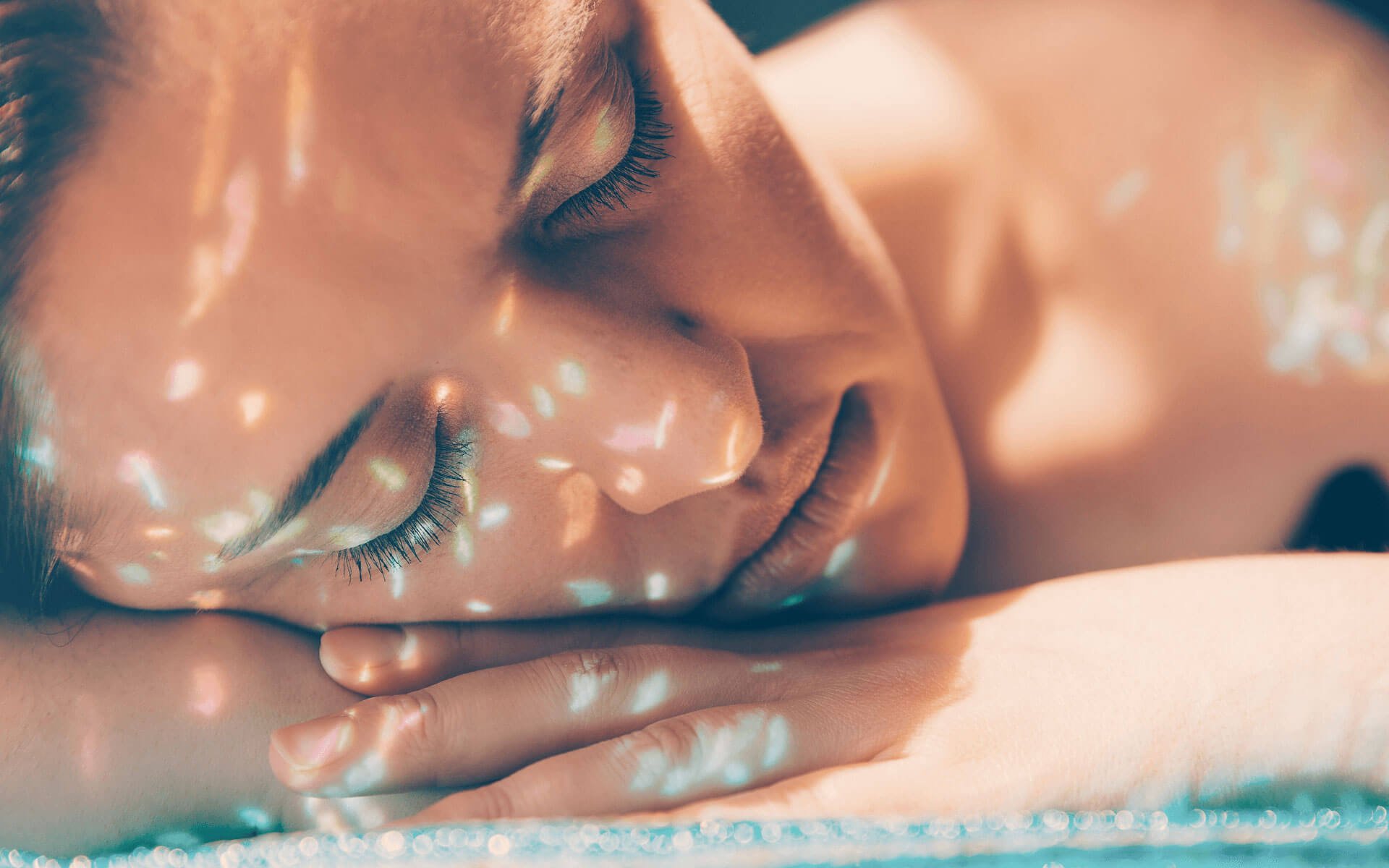 Relaxed face of a woman receiving a reiki healing treatment